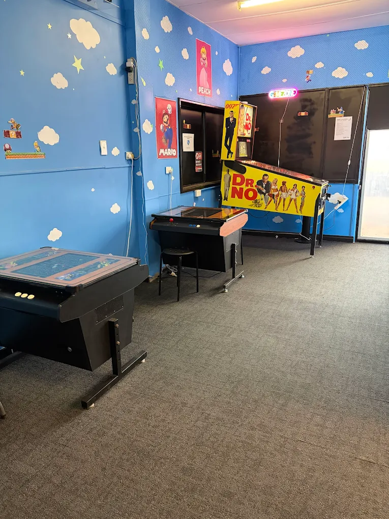 The arcade room at Somewhere to Go featuring classic pinball and arcade machines